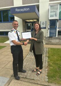 Jill Nooij, Carer Awareness and Voice Coordinator, presenting the Carers Friendly Tick Award - Employer to DCC Dan Vajzovic, BCH Equality, Diversity, and Inclusion Lead
