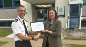 Jill Nooij, Carer Awareness and Voice Coordinator, presenting the Carers Friendly Tick Award - Employer to DCC Dan Vajzovic, BCH Equality, Diversity, and Inclusion Lead