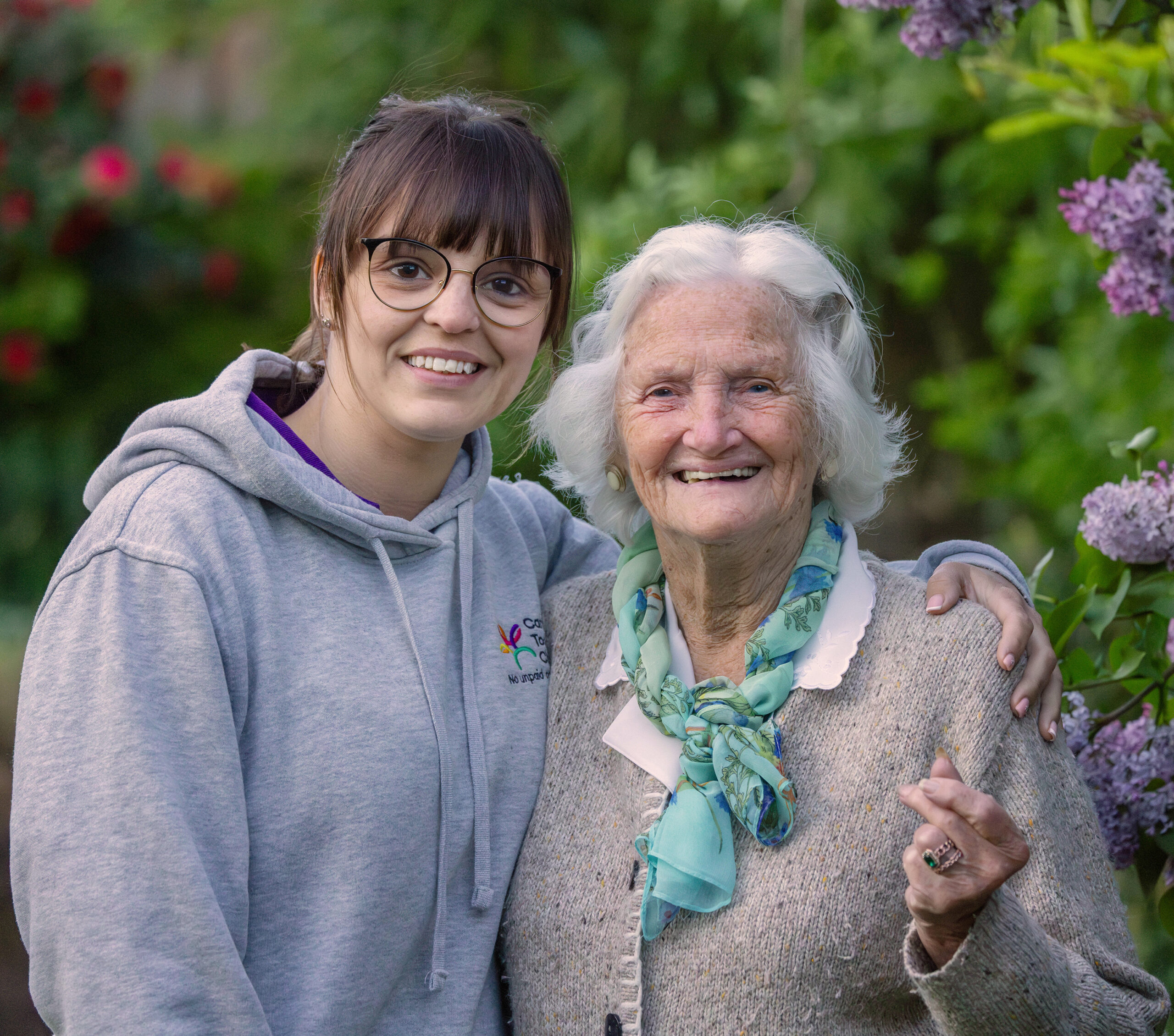 Care Professional in garden with a lady who she supports